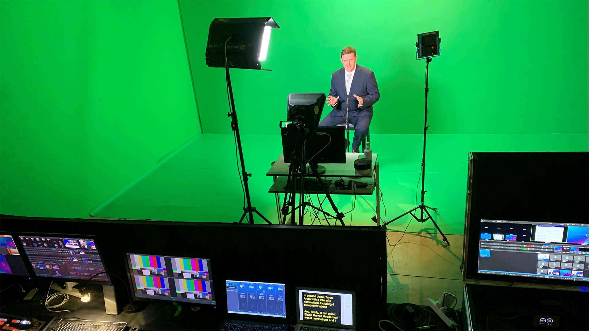 Reporter on a green screen set in front of a camera